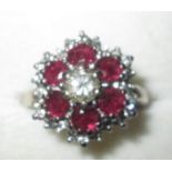 18 ct white gold cluster ring set with six rubies around a single diamond with chip diamond