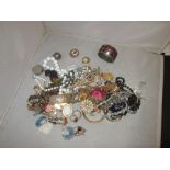 Bag of assorted costume jewellery : brooches, necklaces, earrings,