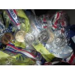 Box of various swimming medals from the 1990s awarded to Lindsay Powell