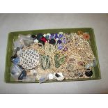 Tray of costume jewellery, buttons, simulated pearls, compact etc.