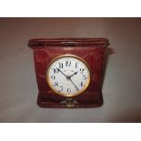 Vintage 8 day alarm clock with painted enamel dial in crocodile skin case