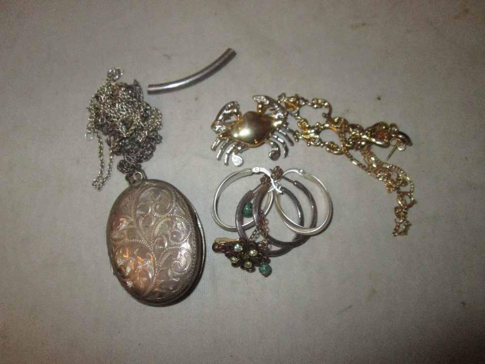 Silver photo locket, silver chains, earrings, gold plated brooch etc.