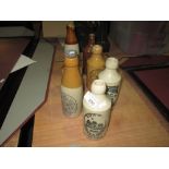 7 x Assorted stoneware advertising bottles : Roses of Weston, Martins of Salisbury,