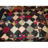 AN interesting early 20th century patchwork bed spread 190 cms x 190 cms