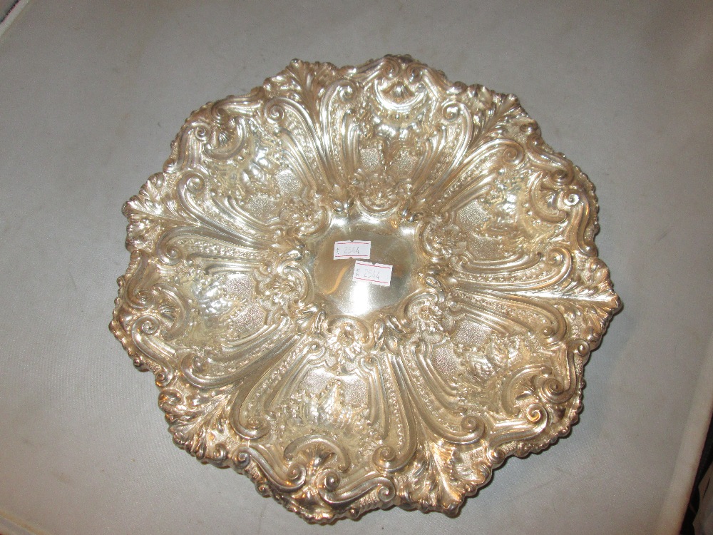 Late 19th century Portuguese silver dish with repousse decoration 28 cms in diameter 366 g