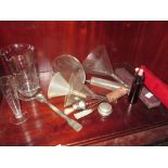 Shelf of vintage medical equipment, glass measures, syringe, razor etc.