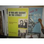 Assorted reproductions of World War II posters mounted on hardboard