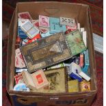 A box of advertising tins and playing cards.