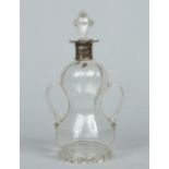 A Victorian glass twin handled decanter with silver collar and of double gourd form with stopper
