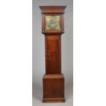 A Georgian oak 8 day longcase clock. Having caddie top and with turned column supports.