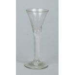 A Georgian wine glass with a bell shaped bowl raised on a single series airtwist stem, 15.25cm.