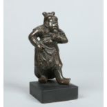 A 19th century Chinese patinated bronze figure of a bearded deity Guanyu,