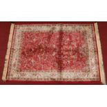A red ground cashmere rug with a tree of life design, 1m 40cm x 1m 90cm. Condition Report.