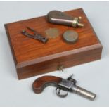 A 19th century Belgian box lock pocket pistol in case and with accoutrements.
