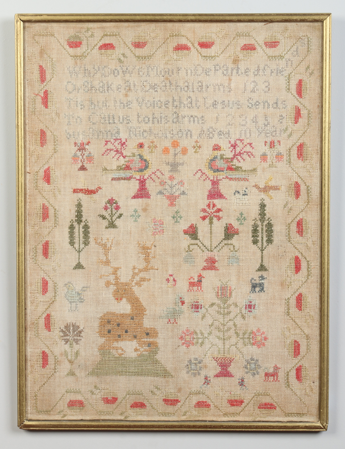 A 19th century woolwork sampler in later frame.