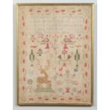 A 19th century woolwork sampler in later frame.