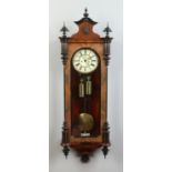 A 19th century walnut cased 8 day Vienna wall clock with ebonized mouldings.