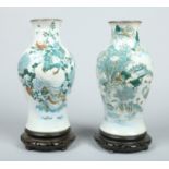 Two Chinese crackle glazed vases with metal mounted rims and raised on hardwood plinths.