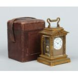 A 19th century lacquered brass carriage clock of architectural form in fitted leather case.