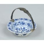 A small 18th century Chinese blue and white lobed bowl with Dutch silver swing handle.