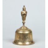 A 19th century Tibetan bronze prayer bell with figural handle and engraved with birds and scrolling