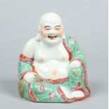 An early 20th century Chinese figure formed as a seated Hotei.