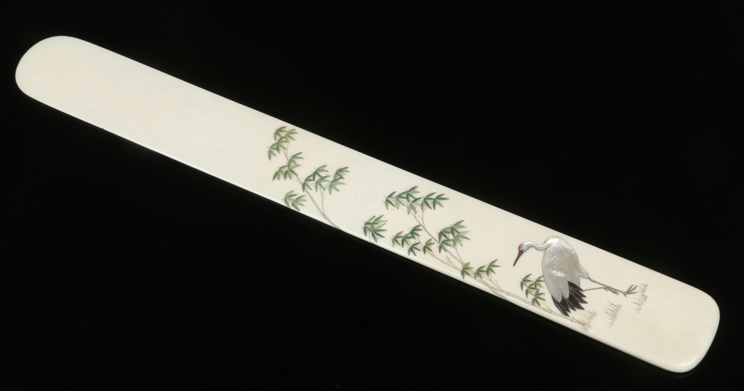 A Japanese Meiji period Shibayama ivory page turner. Decorated with a crane and bamboo soots.