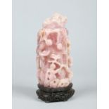 An early 20th century Chinese rose quartz jar and cover raised on a pierced hardwood plinth.