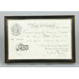 A Bank of England white five pound note in frame. 15th May 1952, X80 040095, chief cashier P. S.