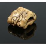 A Japanese early 19th century carved ivory netsuke. Formed as a lotus root issuing plants, 3.