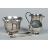 A George V planished silver presentation sugar bowl and sparrow beak cream jug with double