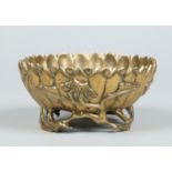 A Chinese polished bronze bowl formed as a lotus flower and raised on a naturalistic branch moulded