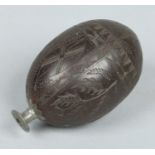 An 18th century carved coconut bugbear powder flask.