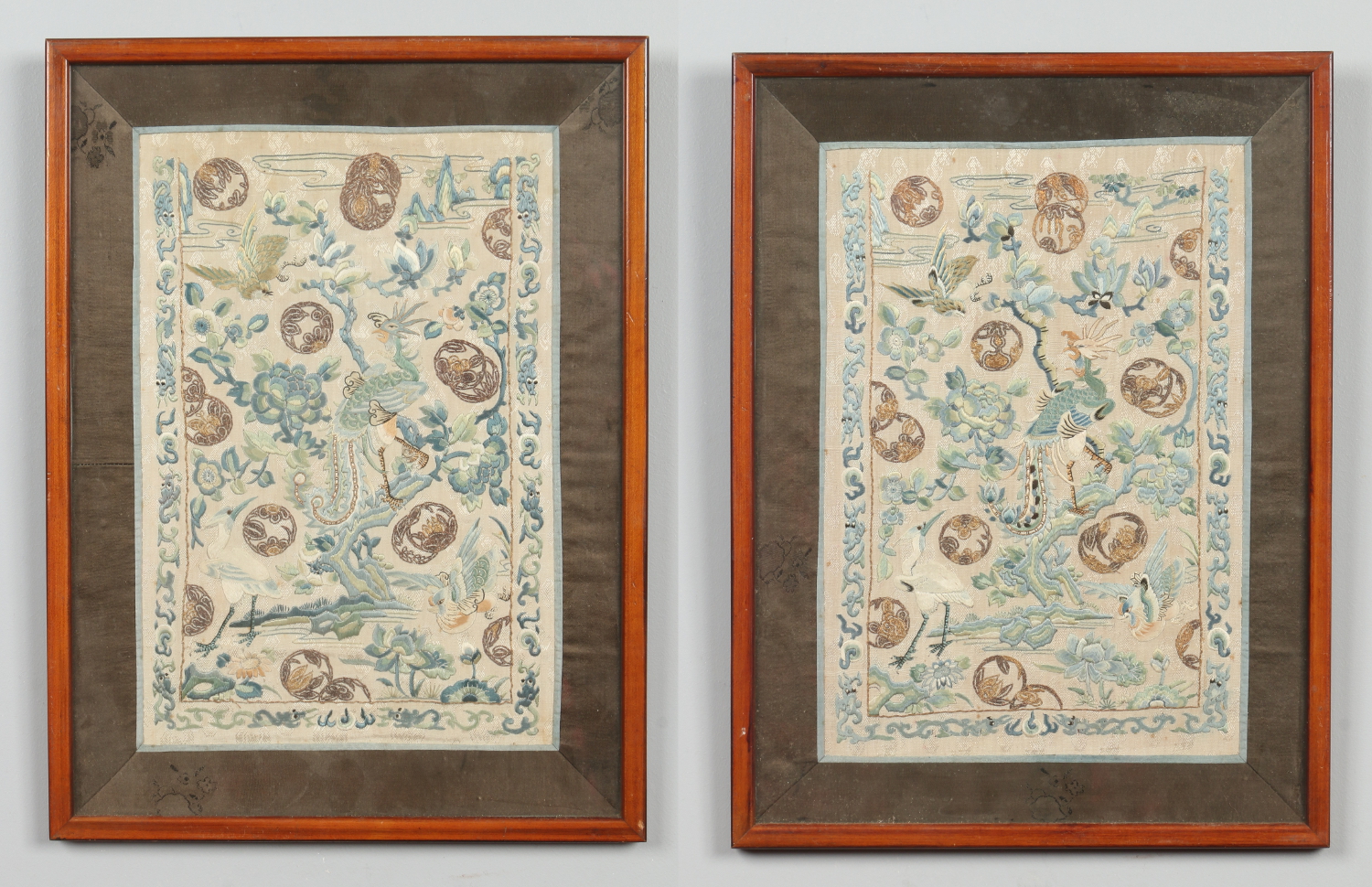 A pair of Chinese framed 19th century embroidered silk panels.