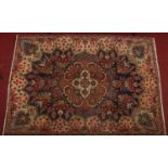 A Persian Tabriz hand woven blue ground rug with a floral design, 2m x 2m 83cm.