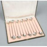 A cased set of 12 Chinese silver plated straw spoons for ice tea.