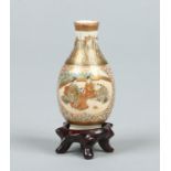 A Japanese Meiji period miniature Satsuma bottle vase on hardwood stand.