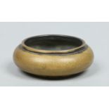 A 19th century small Chinese polished bronze censor with gold splashed decoration.