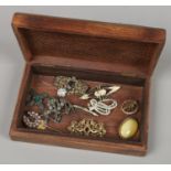 A pierced hardwood jewellery box and small collection of vintage costume jewellery.