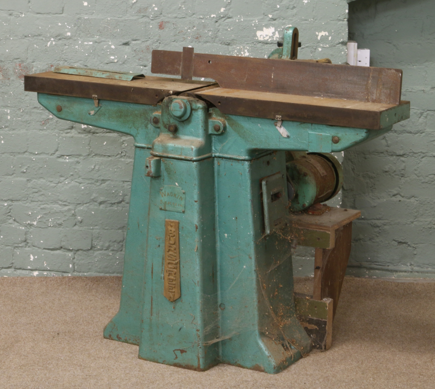 A large Wadkin Bursgreen planer on stand, electrical motor driven.