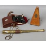 A brass and leather 3 drawer telescope along with a pair of Carl Zeiss 8 x 30 binoculars and a