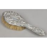 An Art Nouveau silver backed hair brush assayed Birmingham 1910.