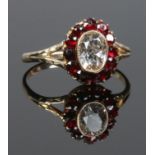 A 9ct gold garnet and white paste coronet cluster ring. Size O.