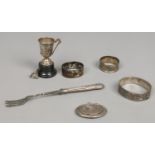A collection of various silver to include napkin rings, trophy, bangle,