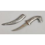 An Indian Mughal style dagger in metal scabbard with white metal inlay and the hilt formed as a