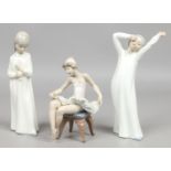 A Lladro figure of a seated ballet dancer, along with two Nao figures of young girls.