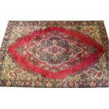 A red ground Persian Tabreze carpet with floral medallion design,