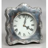 A silver fronted quartz desk clock assayed London 1986.