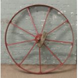 A painted iron cartwheel.