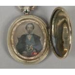 A Victorian gilt metal locket set with a Victorian portrait.